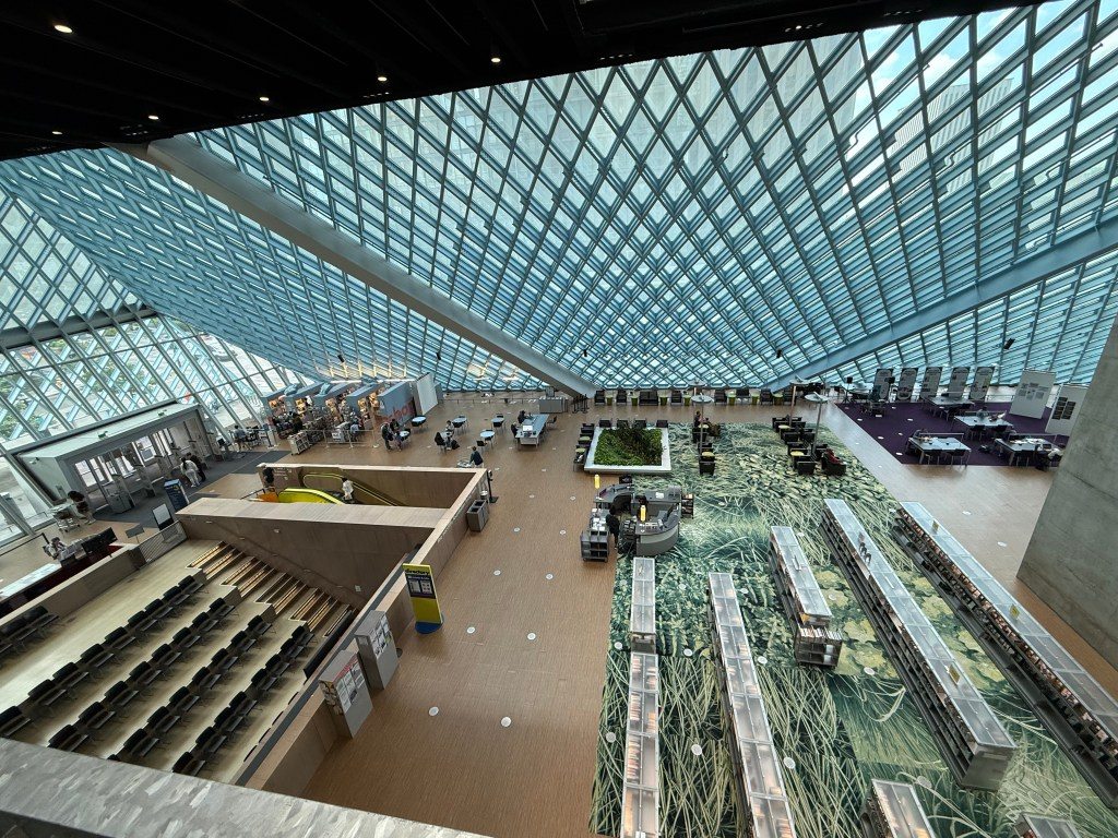 Interior view of the Seattle Central Library showcasing its unique architectural design with glass walls and open spaces.