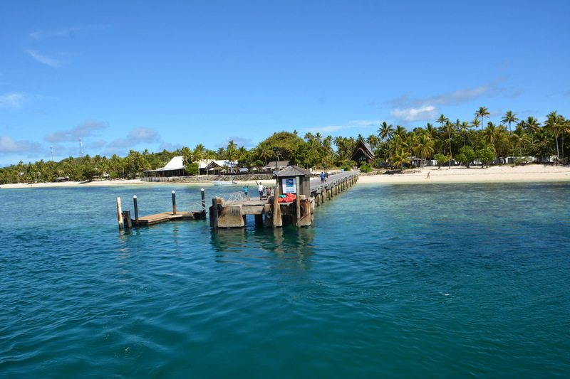 View of the Maui Island on a beautiful sunny day with two men at the port waving to the camera.