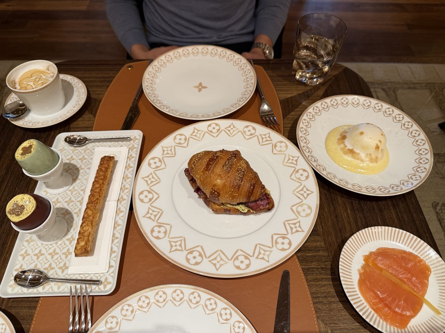 Our breakfast spread at Le Café Louis Vuitton: truffle eggs, a wagyu pastrami croissant, and eggs with smoked salmon.