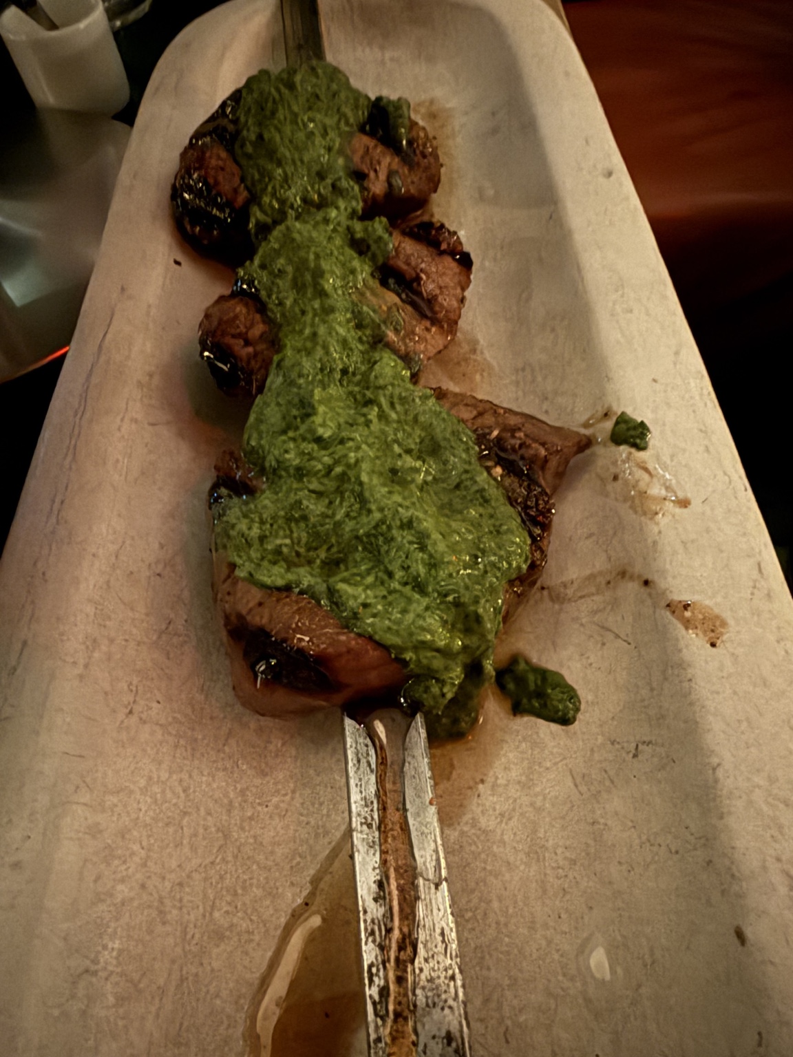 Grilled skewers topped with green sauce at Zou Zou’s